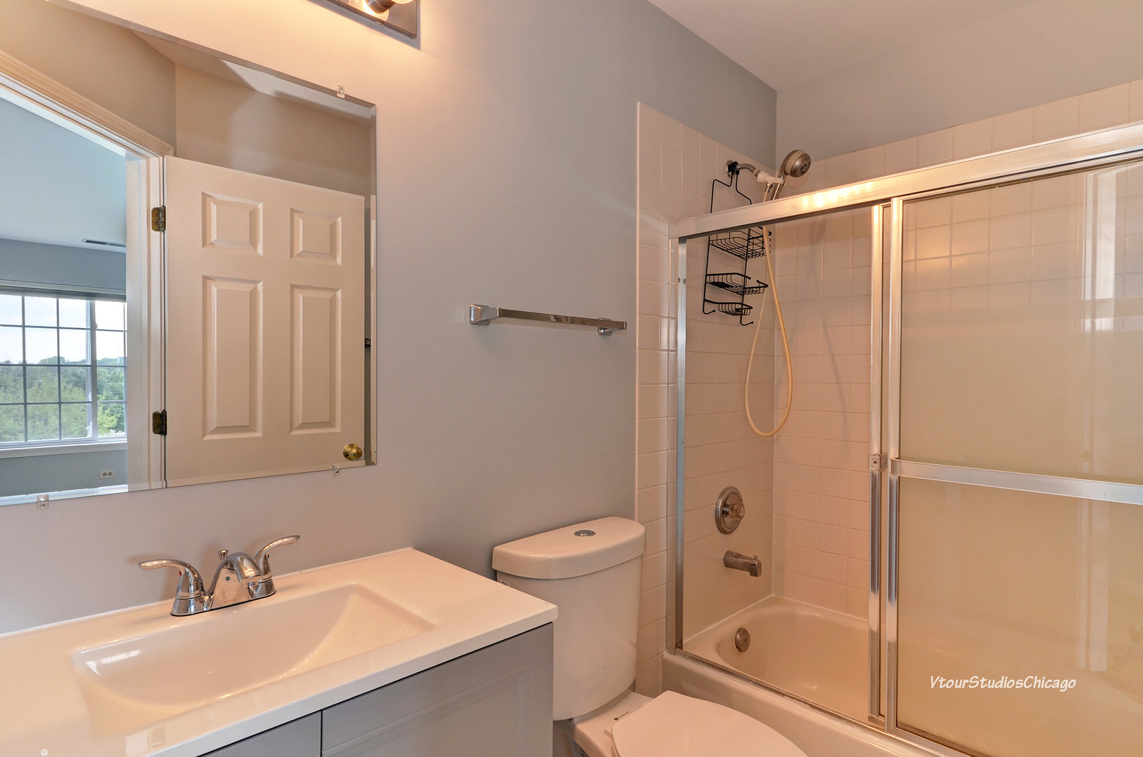 5451 Elizabeth Place Rolling Meadows, IL 60008 - Photo 24 of 34 a bathroom with a sink a mirror and a shower