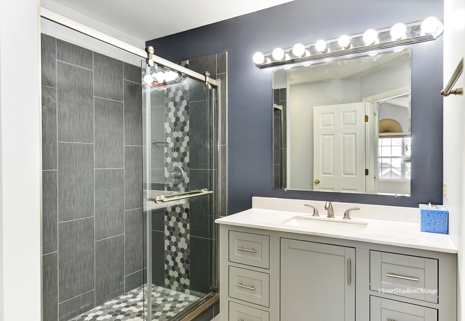 5451 Elizabeth Place Rolling Meadows, IL 60008 - Photo 29 of 34 a bathroom with a shower sink and mirror