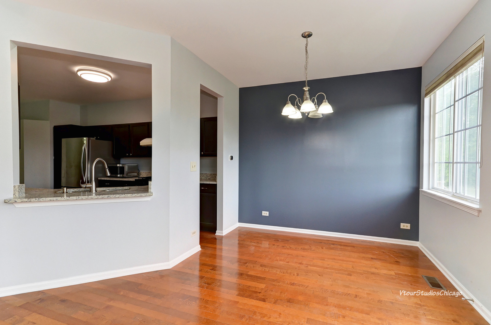 5451 Elizabeth Place Rolling Meadows, IL 60008 - Photo 10 of 34 a view of a room with wooden floor and chandelier