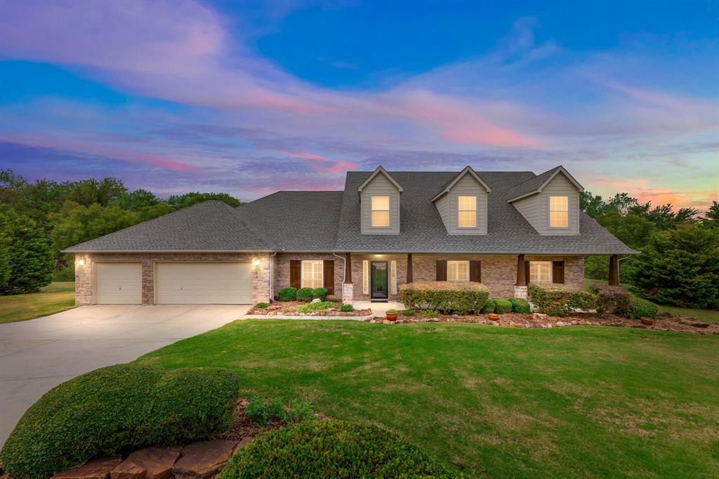 a front view of a house with a garden and plants