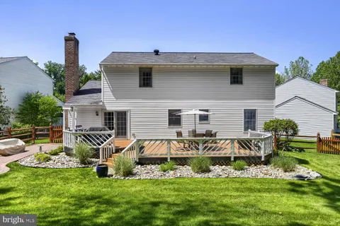 a view of a house with a yard patio and sitting area
