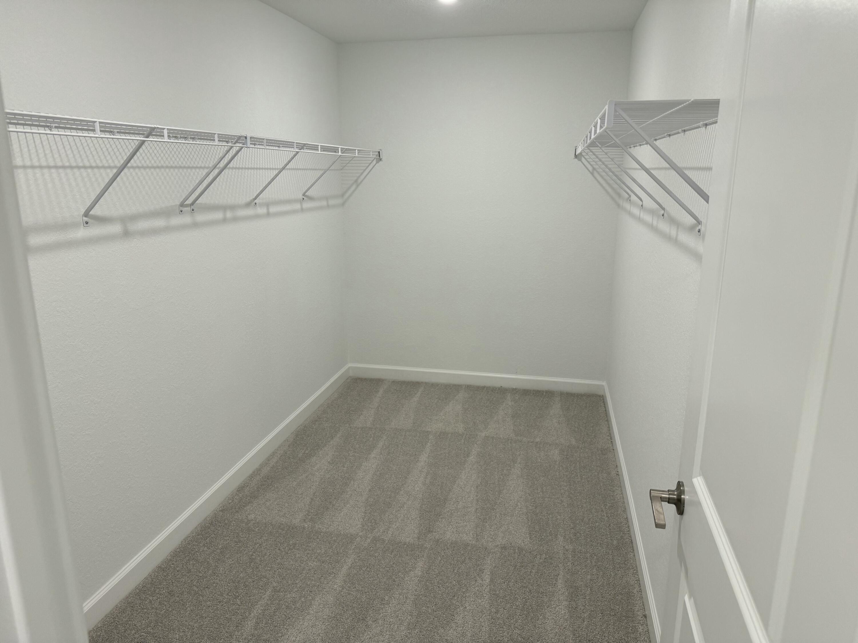 10501 Northwest Suncrest Loop Port St. Lucie, FL 34987 - Photo 15 of 33 a view of a room with racks on the wall