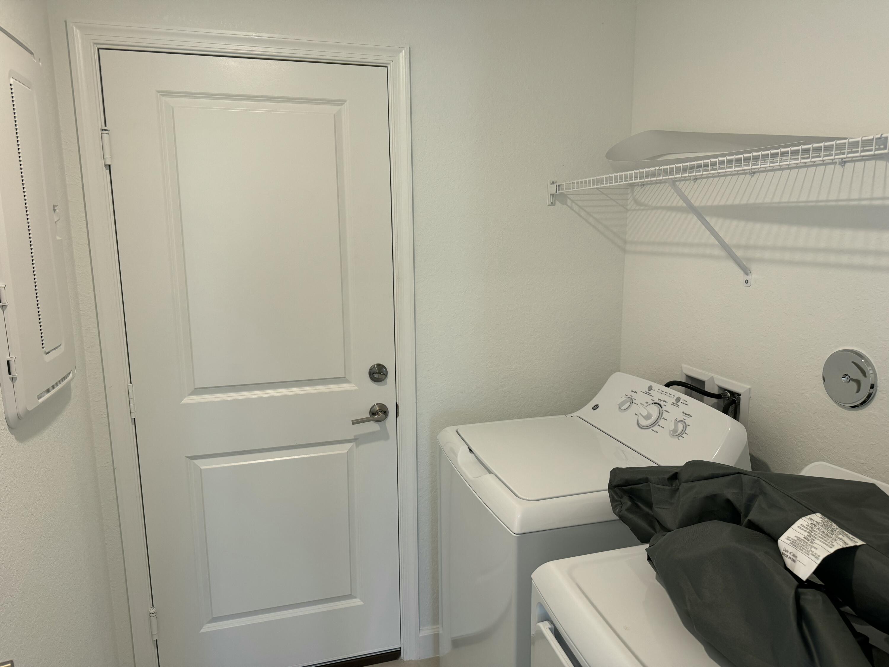 10501 Northwest Suncrest Loop Port St. Lucie, FL 34987 - Photo 17 of 33 a utility room with dryer and washer