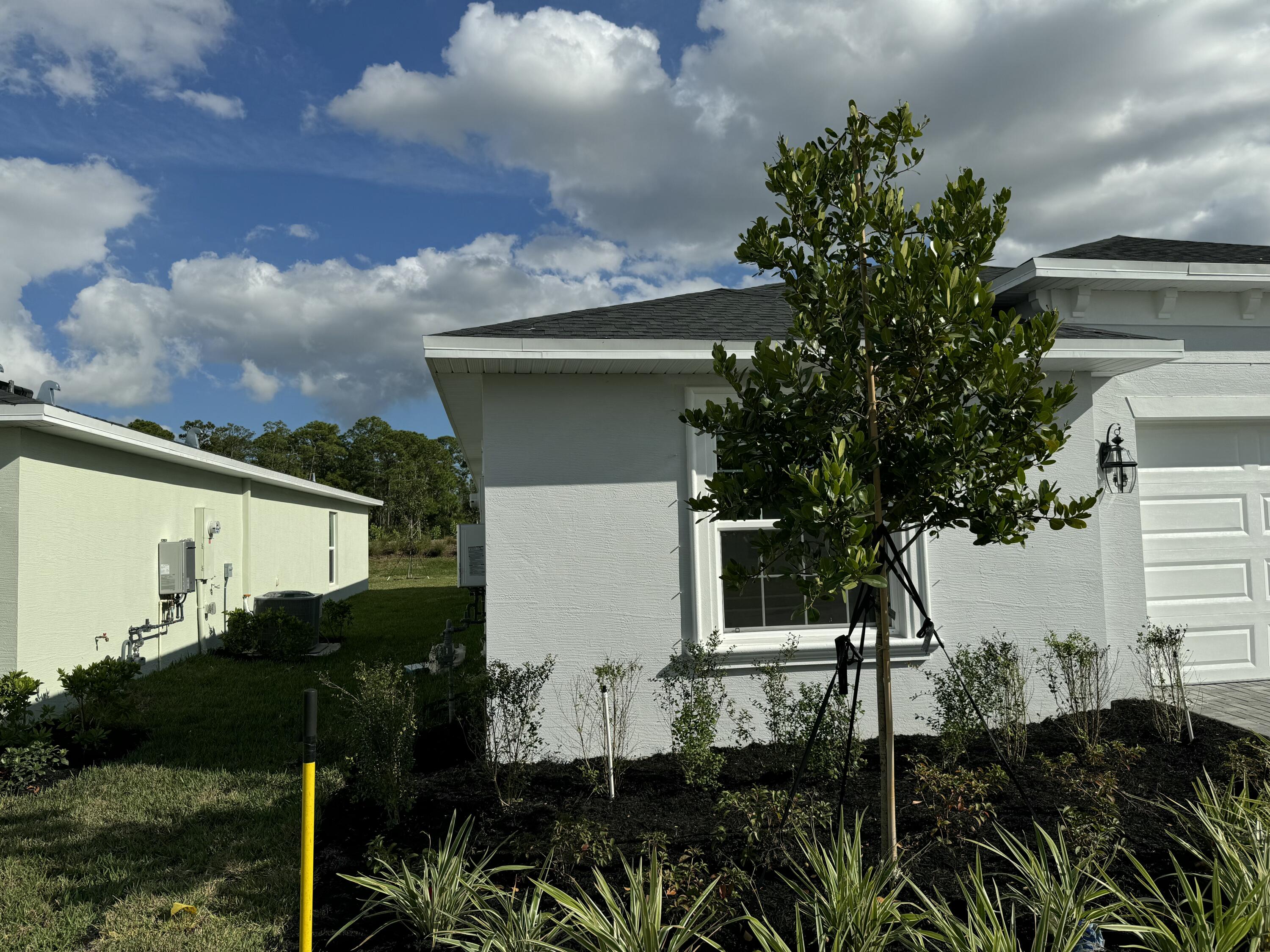 10501 Northwest Suncrest Loop Port St. Lucie, FL 34987 - Photo 2 of 33 a view of a house with a backyard