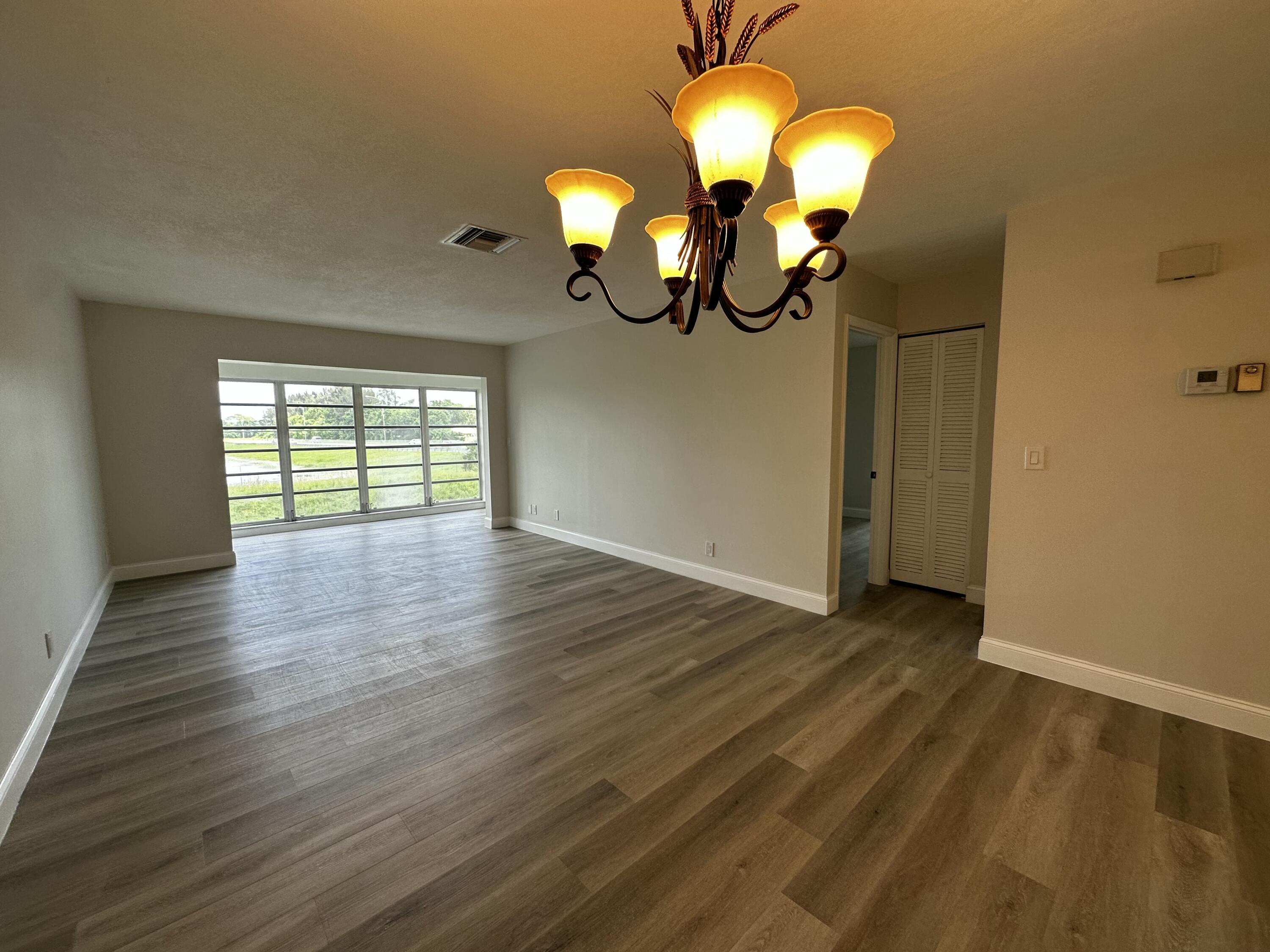 13682 Vía Flora, Unit H Delray Beach, FL 33484 - Photo 15 of 28 a view of a livingroom with wooden floor
