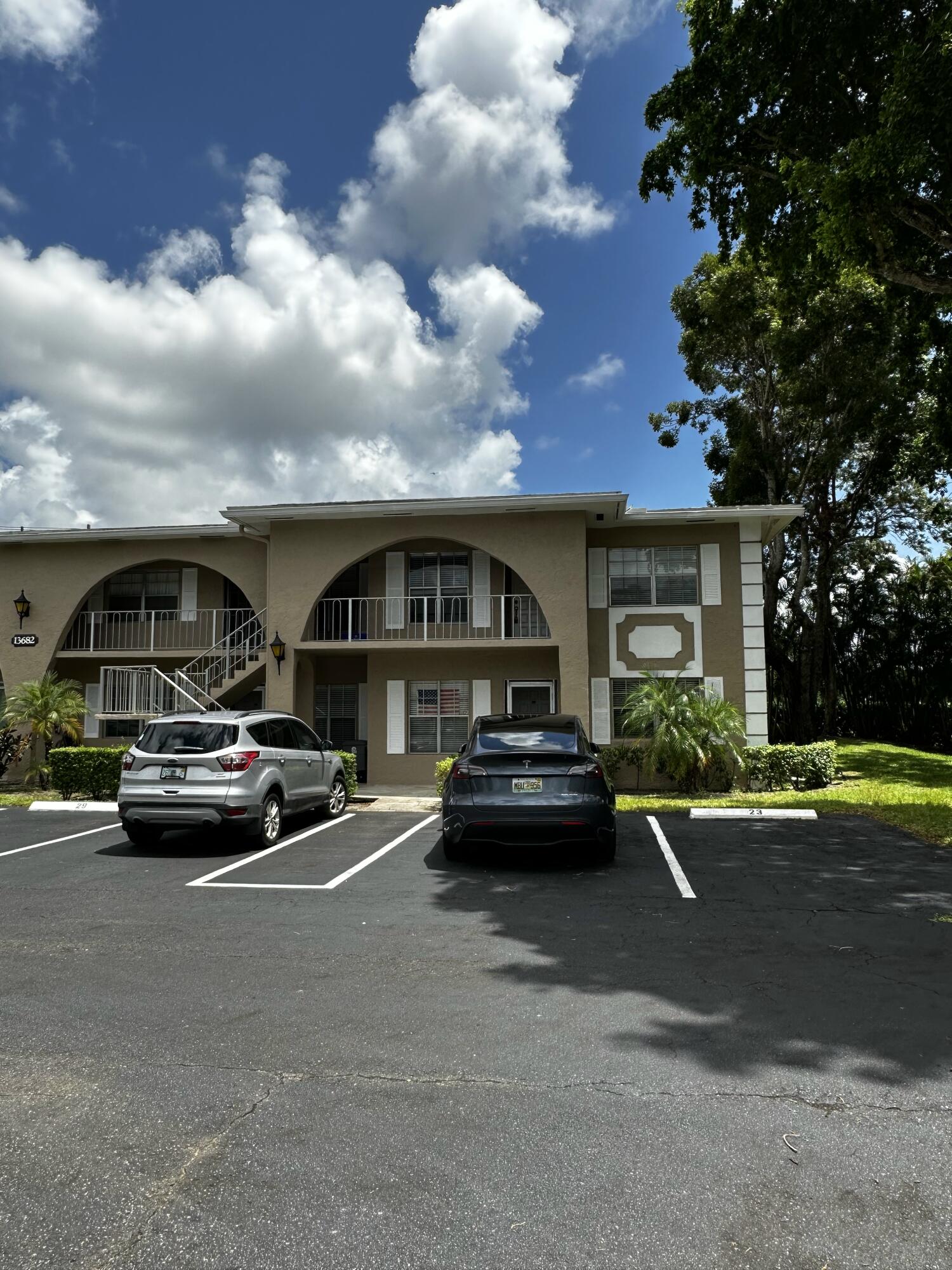 13682 Vía Flora, Unit H Delray Beach, FL 33484 - Photo 2 of 28 a view of street with cars