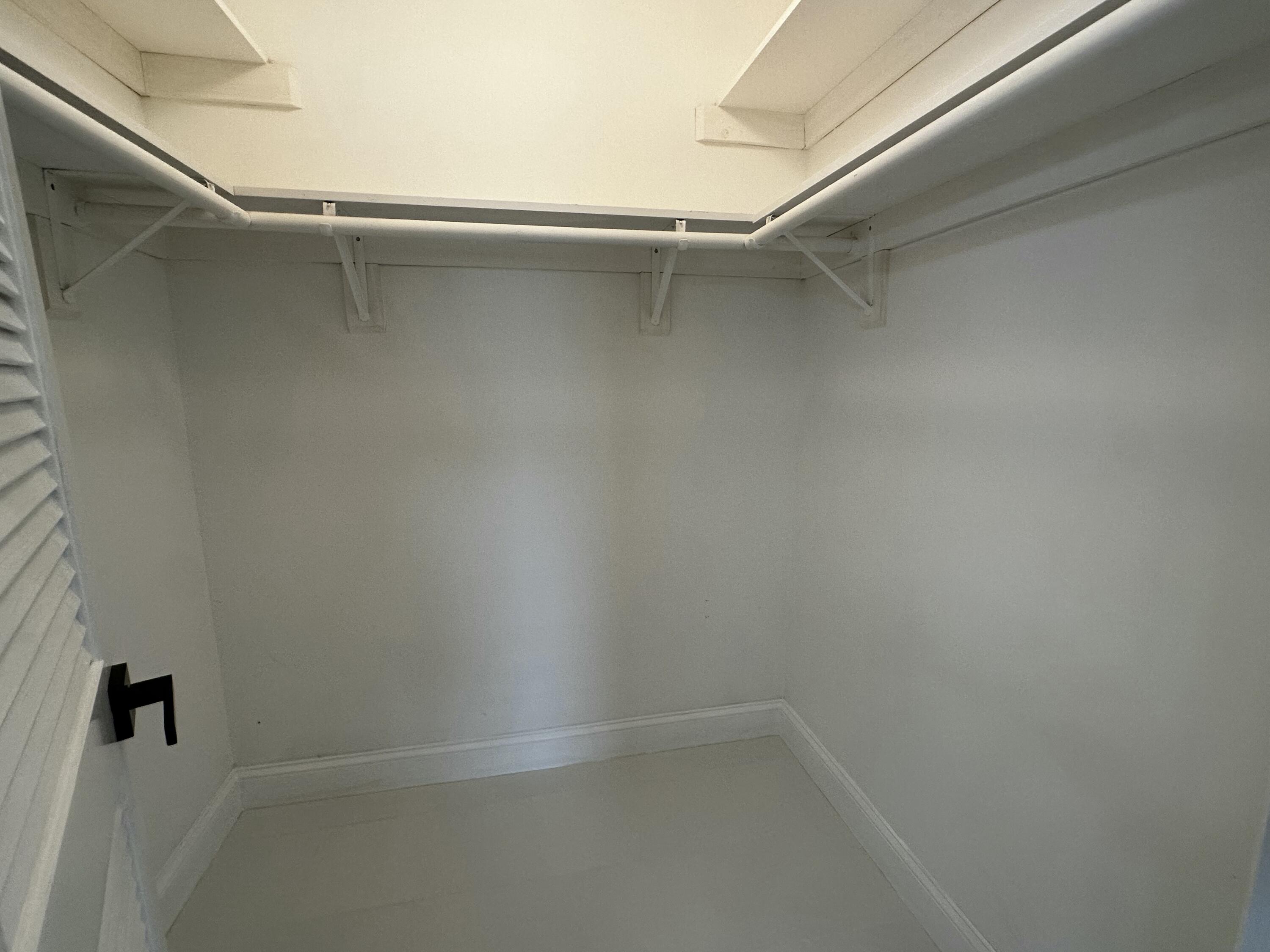 13682 Vía Flora, Unit H Delray Beach, FL 33484 - Photo 21 of 28 a view of an empty walk in closet