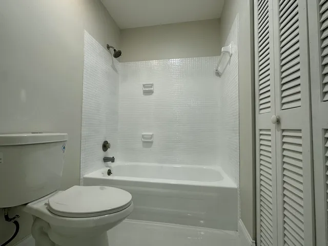 a bathroom with a toilet and a bathtub