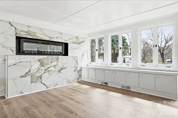 a view of a living room with a fireplace and a large window