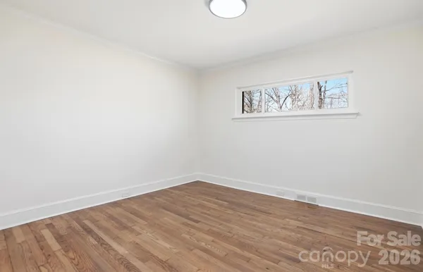 a view of a room with wooden floor