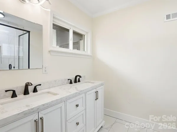 a bathroom with a granite countertop sink a toilet and a shower