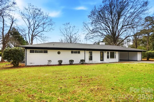 a large house with a large pool in front of it