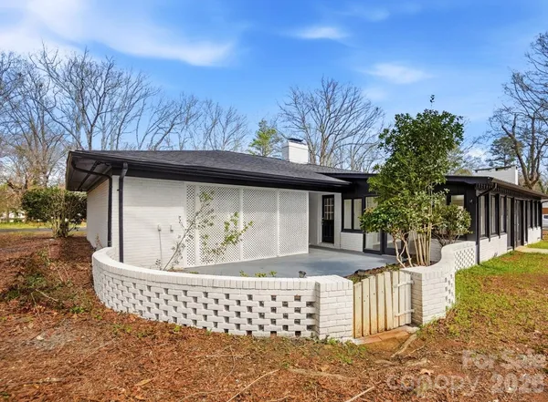 a tall house with trees in front of it