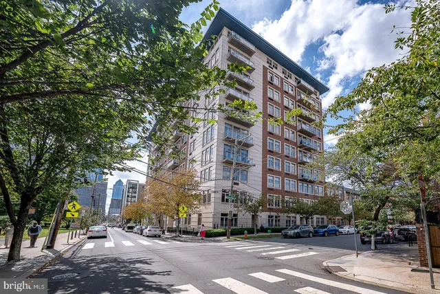 a city street lined with buildings and trees
