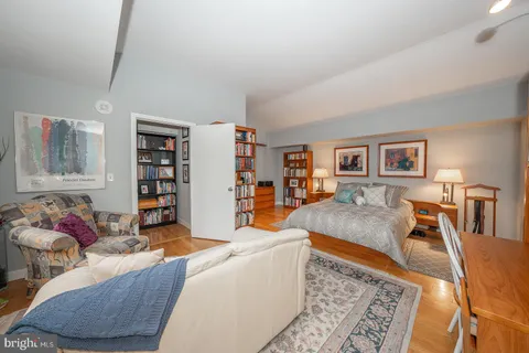 a living room with furniture and a book shelf