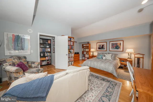 a living room with furniture and a book shelf