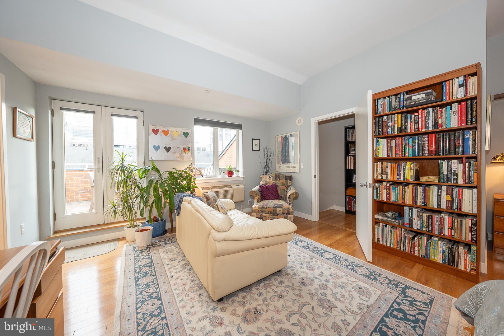 1900 Hamilton Street, Unit D19 Philadelphia, PA 19130 - Photo 16 of 36 a living room with furniture and a book shelf