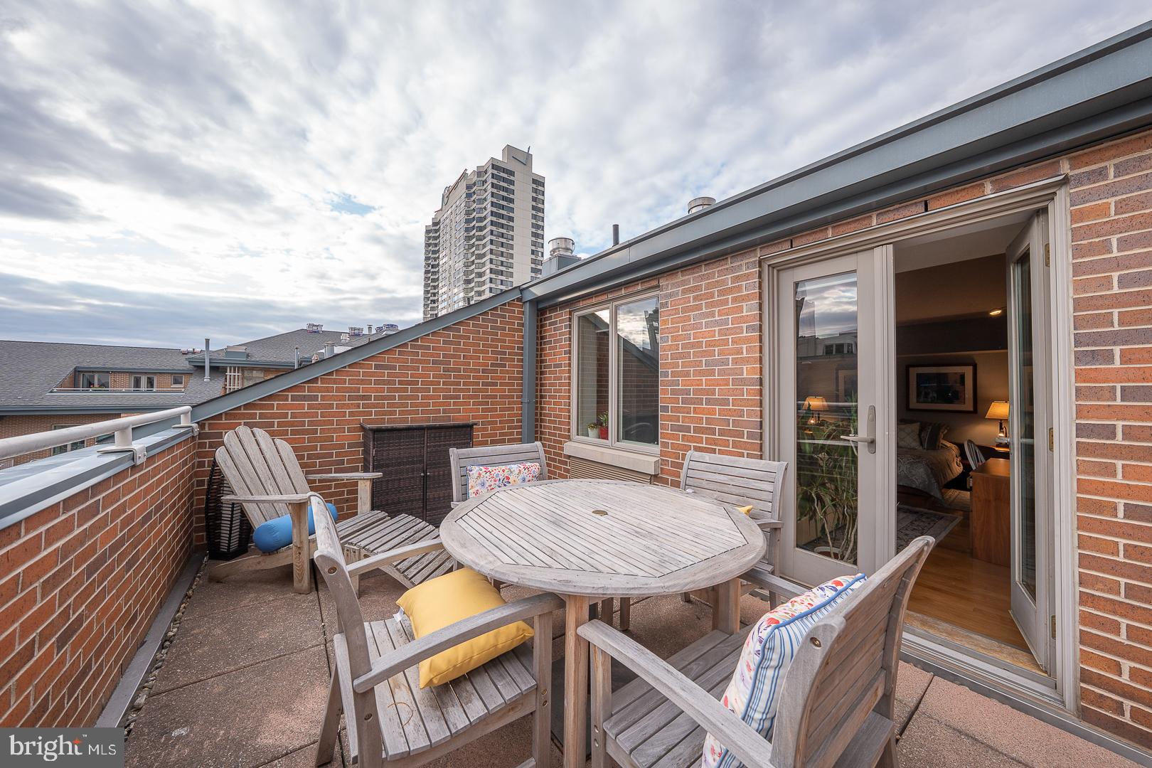 1900 Hamilton Street, Unit D19 Philadelphia, PA 19130 - Photo 18 of 36 a backyard of a house with wooden floor outdoor seating and barbeque oven