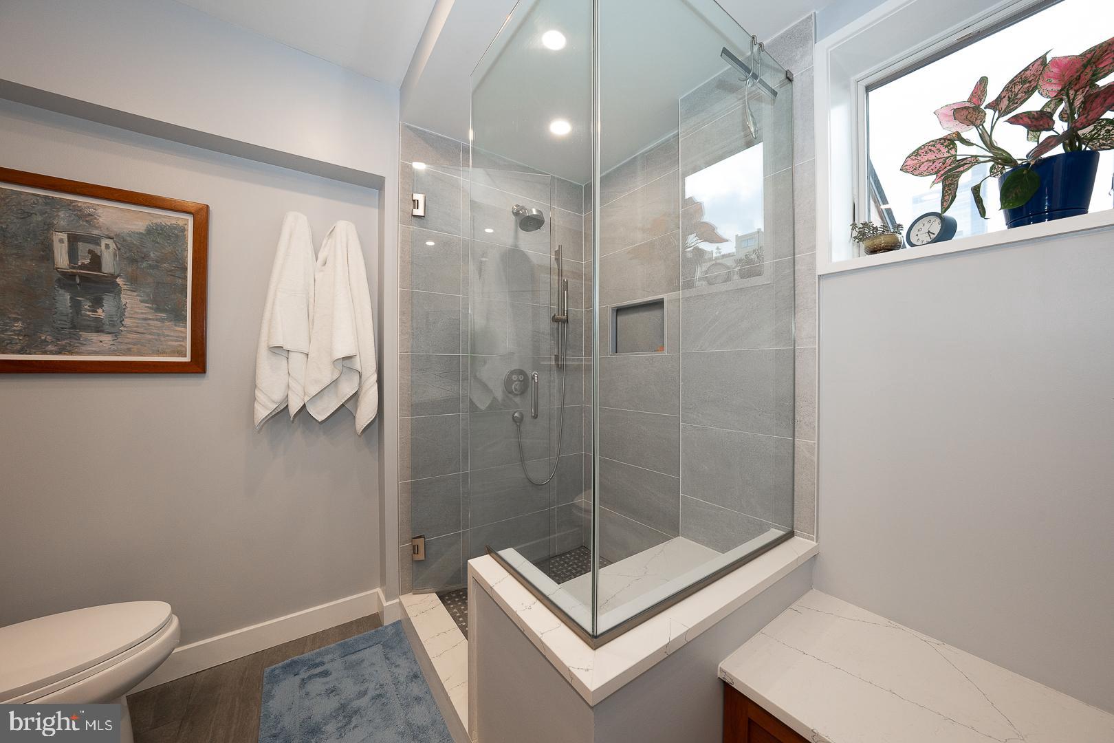 1900 Hamilton Street, Unit D19 Philadelphia, PA 19130 - Photo 20 of 36 a bathroom with a shower a toilet and sink