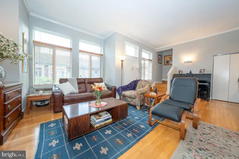 a living room with furniture fireplace and a table