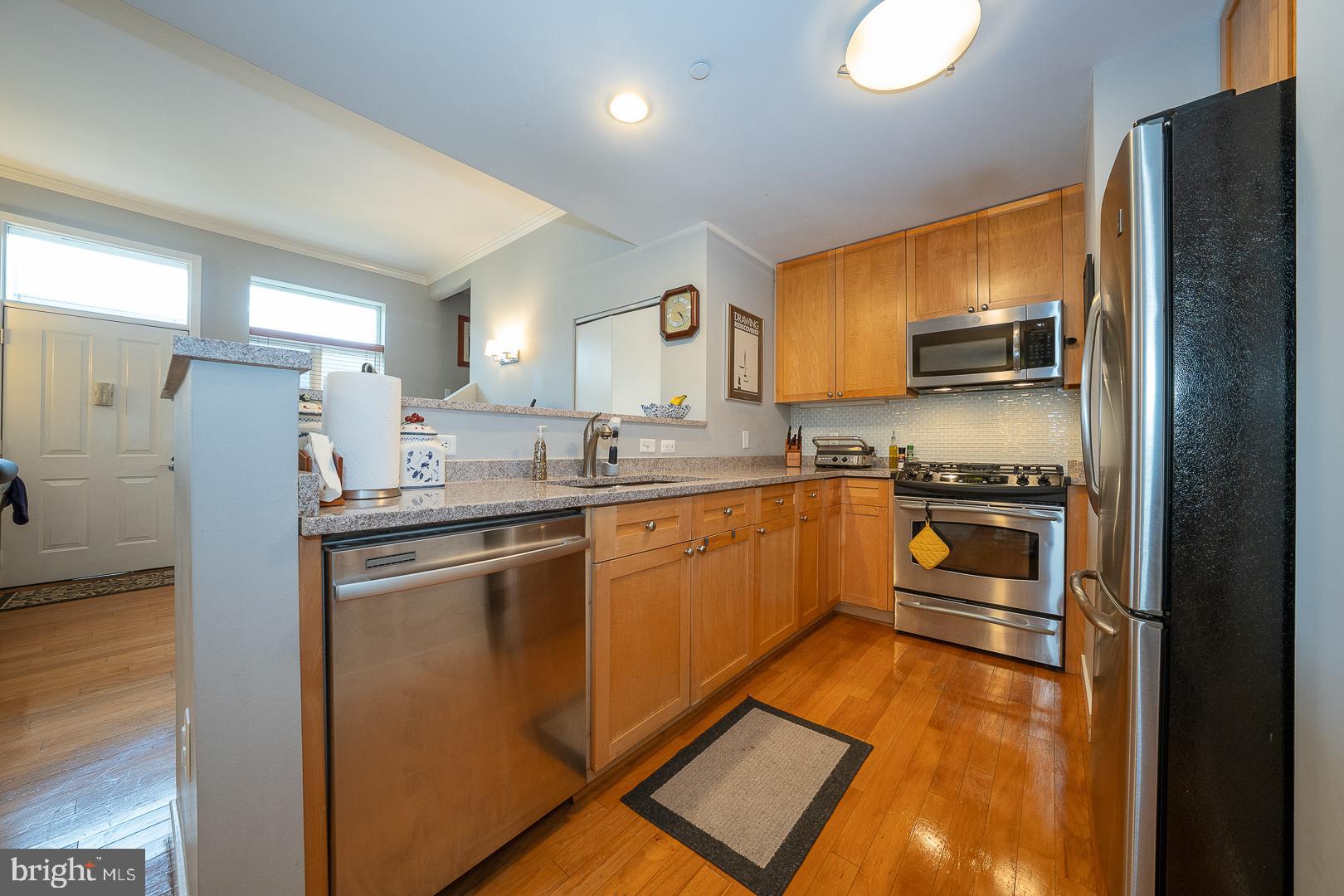 1900 Hamilton Street, Unit D19 Philadelphia, PA 19130 - Photo 10 of 36 a kitchen with stainless steel appliances granite countertop a refrigerator a stove and a sink