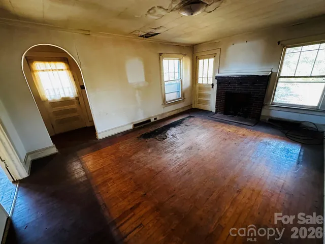 a view of a livingroom with wooden floor and a window