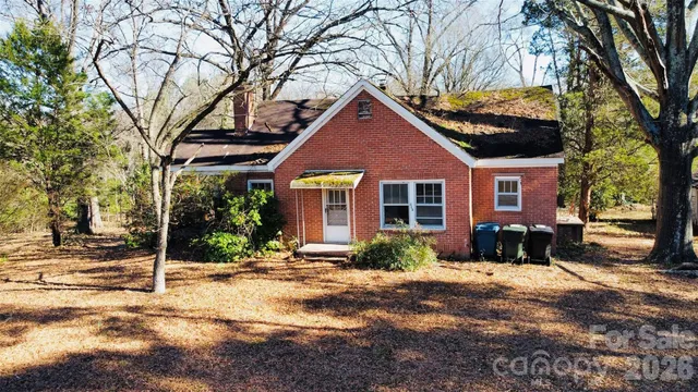 a view of a house with a yard covered in snow