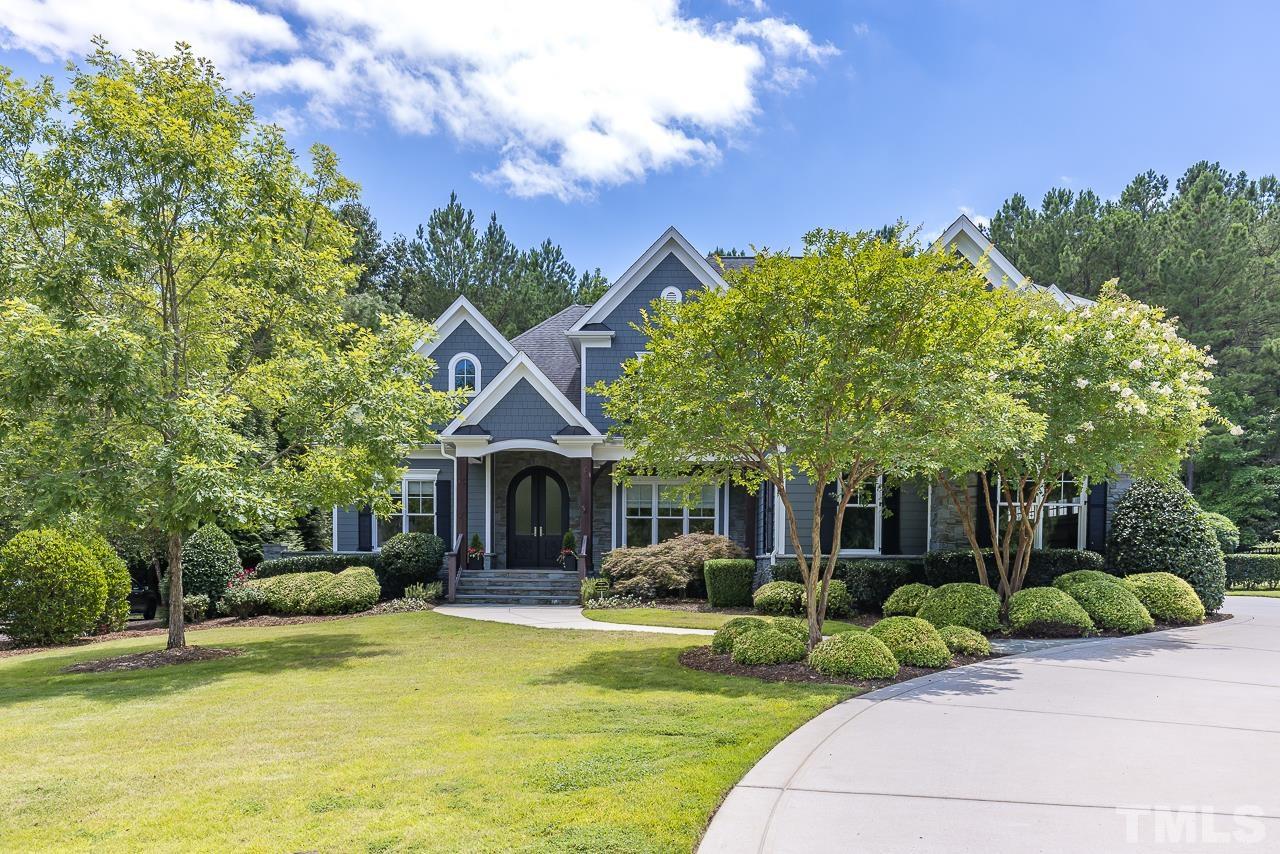 a front view of a house with a yard table and chairs