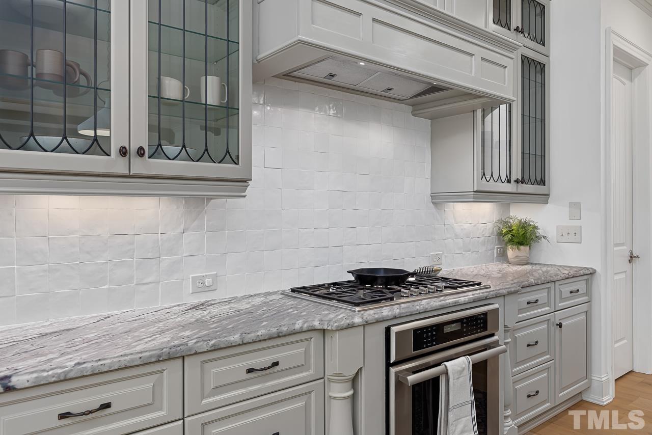 18 Crimson Oak Drive Durham, NC 27713 - Photo 13 of 87 a kitchen with granite countertop stainless steel appliances a stove and white cabinets
