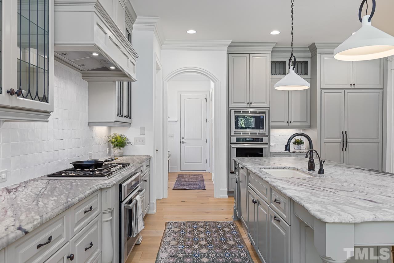 18 Crimson Oak Drive Durham, NC 27713 - Photo 14 of 87 a kitchen with granite countertop a sink stainless steel appliances and cabinets
