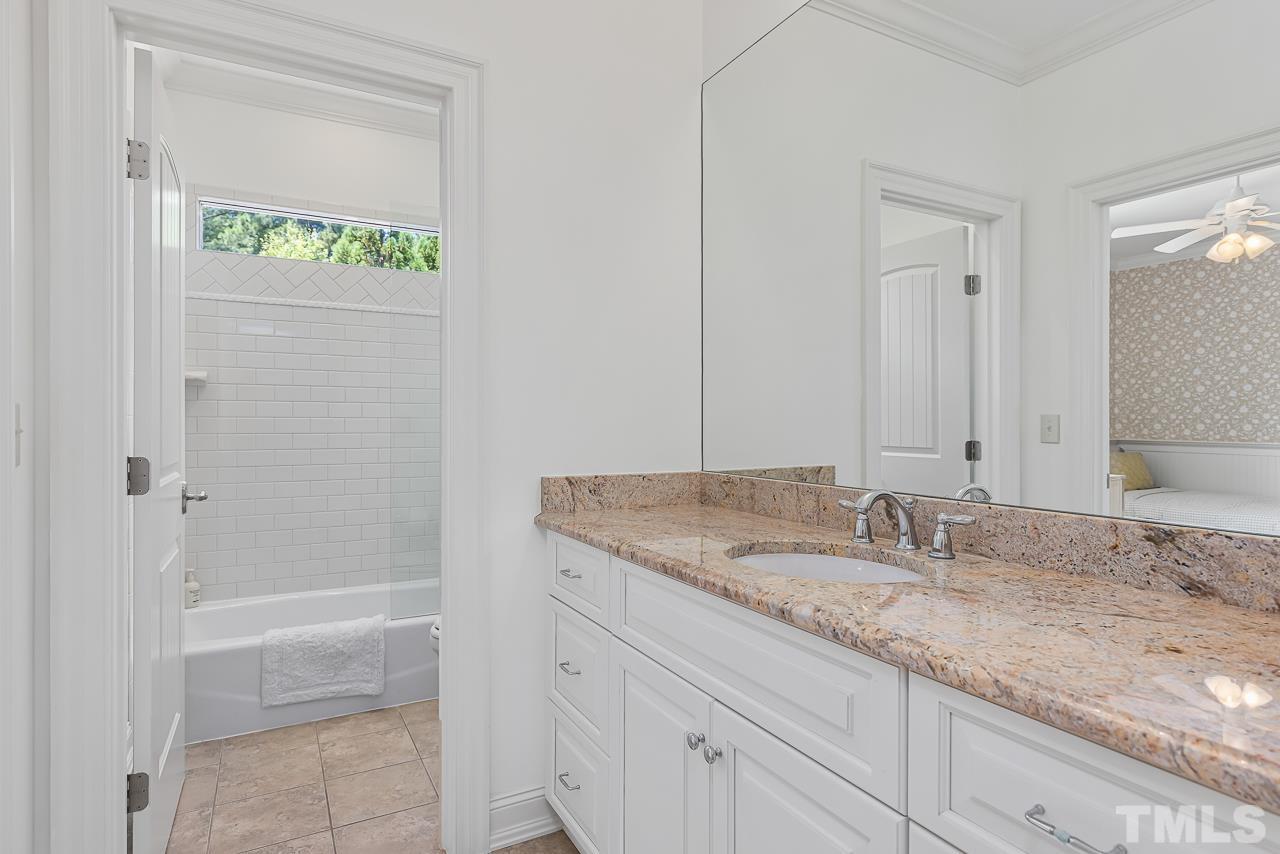 18 Crimson Oak Drive Durham, NC 27713 - Photo 36 of 87 a bathroom with a granite countertop sink and a mirror