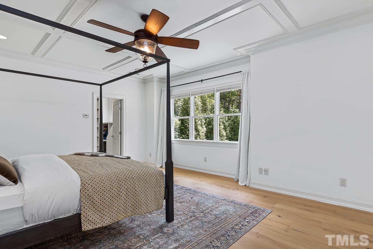 18 Crimson Oak Drive Durham, NC 27713 - Photo 40 of 87 a bedroom with a bed and a chandelier