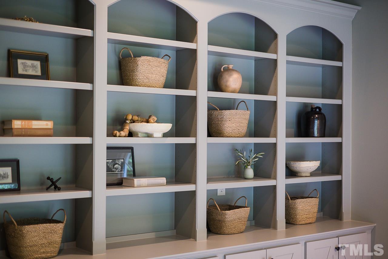 18 Crimson Oak Drive Durham, NC 27713 - Photo 73 of 87 a room with a bookshelf and a potted plant