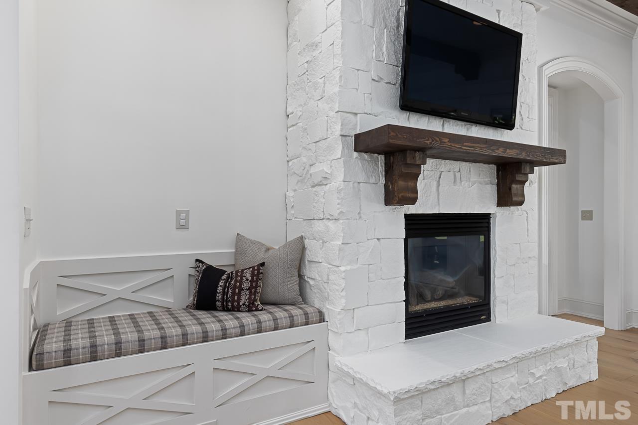 18 Crimson Oak Drive Durham, NC 27713 - Photo 8 of 87 a living room with a fireplace and a flat screen tv