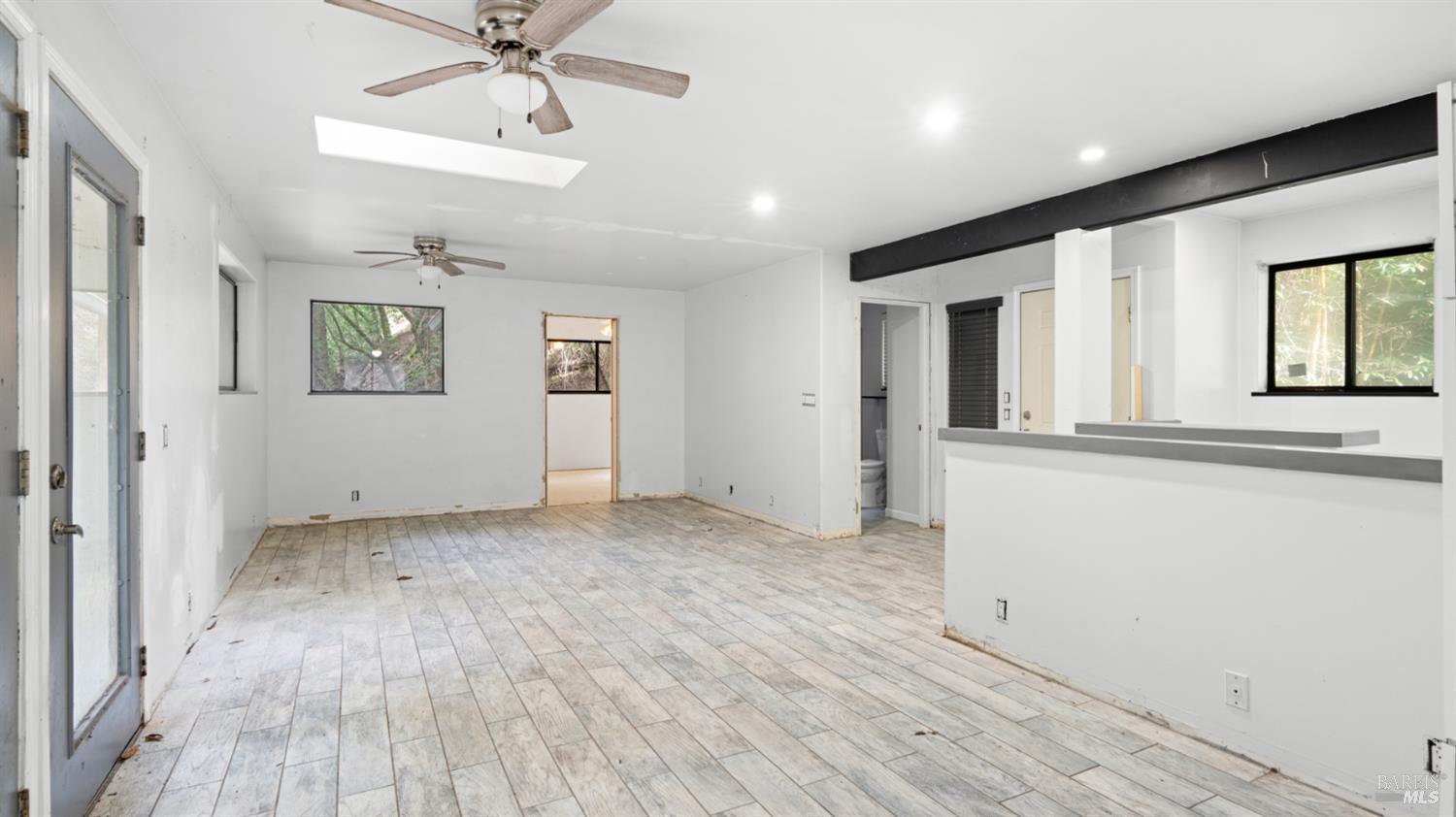 11144 Ice Box Canyon Road Forestville, CA 95436 - Photo 14 of 38 wooden floor in an empty room with a window