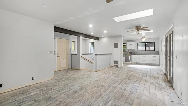 a view of a kitchen with a refrigerator and a sink