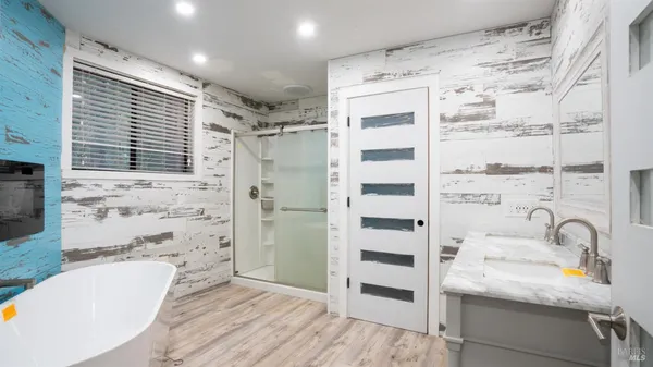 a bathroom with a tub sink and a shower