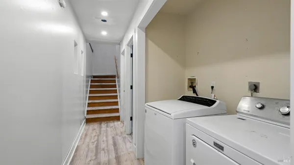 a view of storage and utility room with washer and dryer