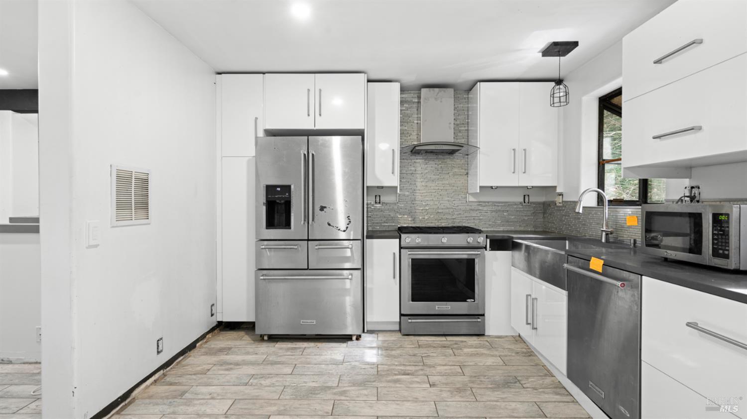 11144 Ice Box Canyon Road Forestville, CA 95436 - Photo 25 of 38 a kitchen with stainless steel appliances a refrigerator sink and microwave