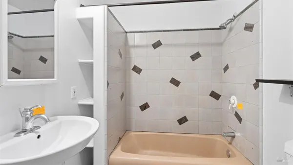 a bathroom with a tub and a shower