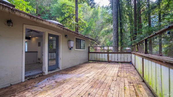 a view of balcony with wooden floor and fence