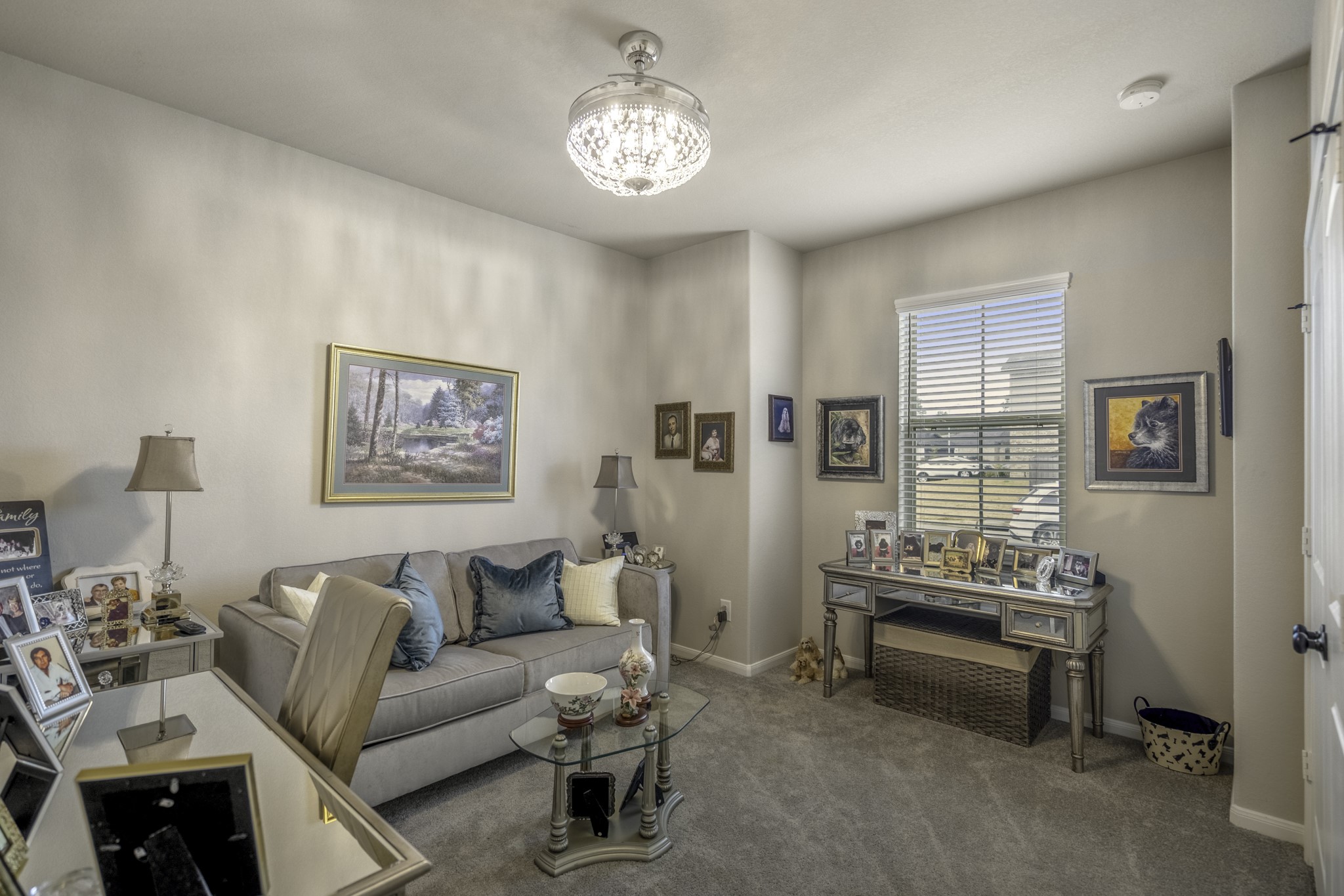 30391 Limber Pines Drive Magnolia, TX 77355 - Photo 14 of 49 Discover a front-facing bedroom adorned with a stunning chandelier, offering a blend of elegance and warmth.