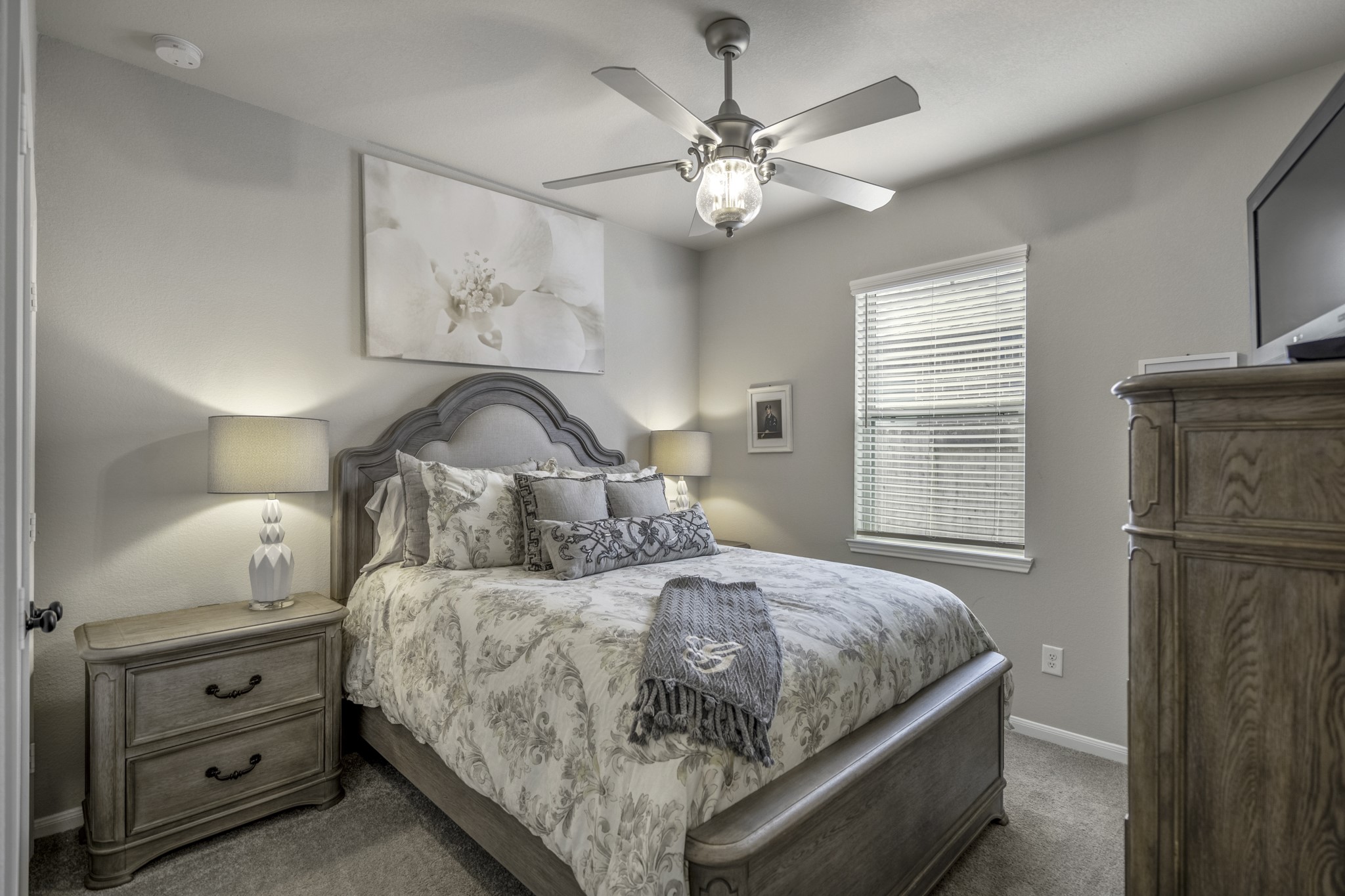 30391 Limber Pines Drive Magnolia, TX 77355 - Photo 16 of 49 This inviting second bedroom offers comfort with a stylish fan and light combo, creating a cozy retreat for relaxation.