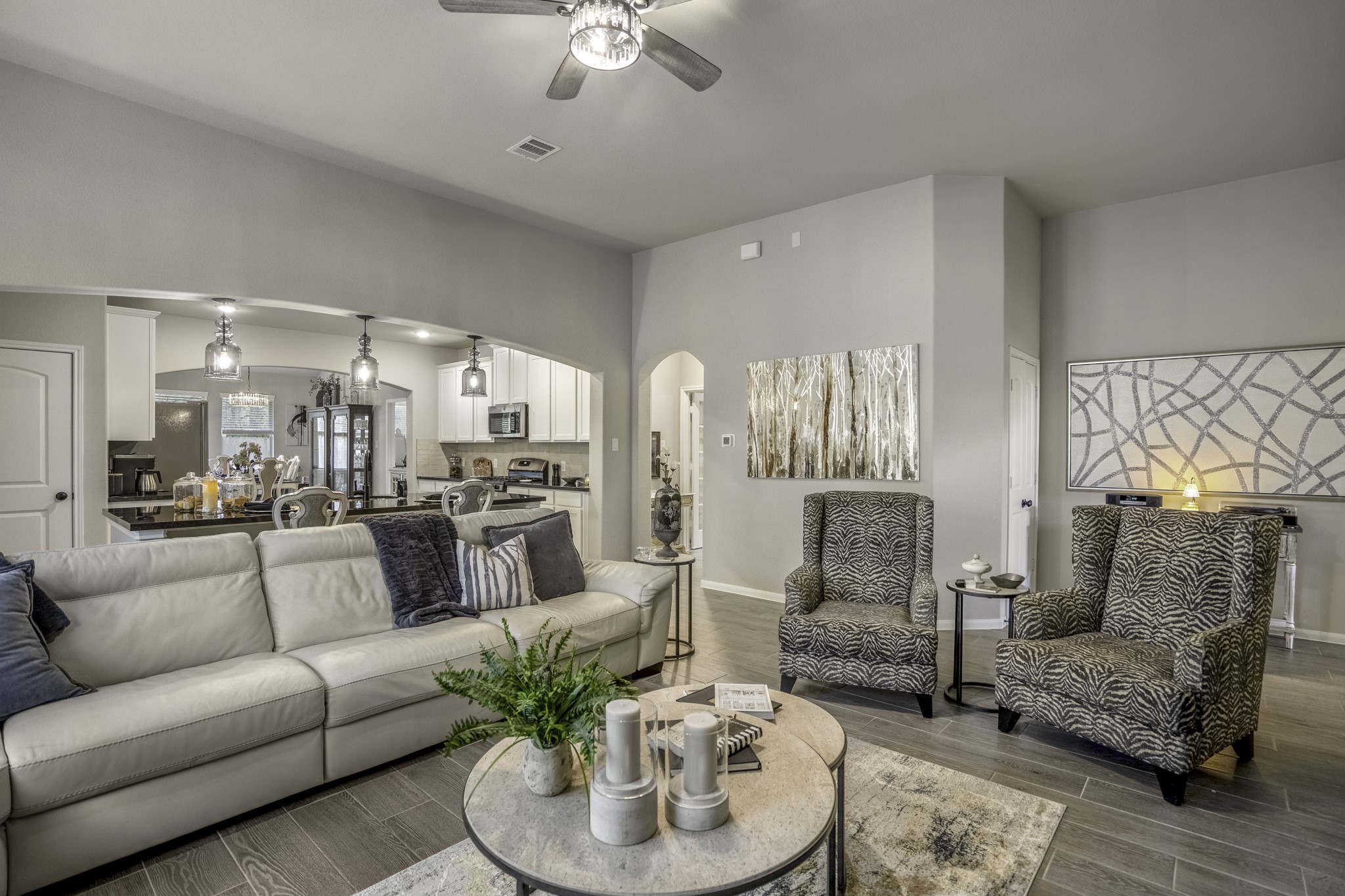 30391 Limber Pines Drive Magnolia, TX 77355 - Photo 20 of 49 Discover seamless living with a spacious, elegantly designed living room that flows effortlessly into a modern kitchen, perfect for entertaining and everyday comfort.