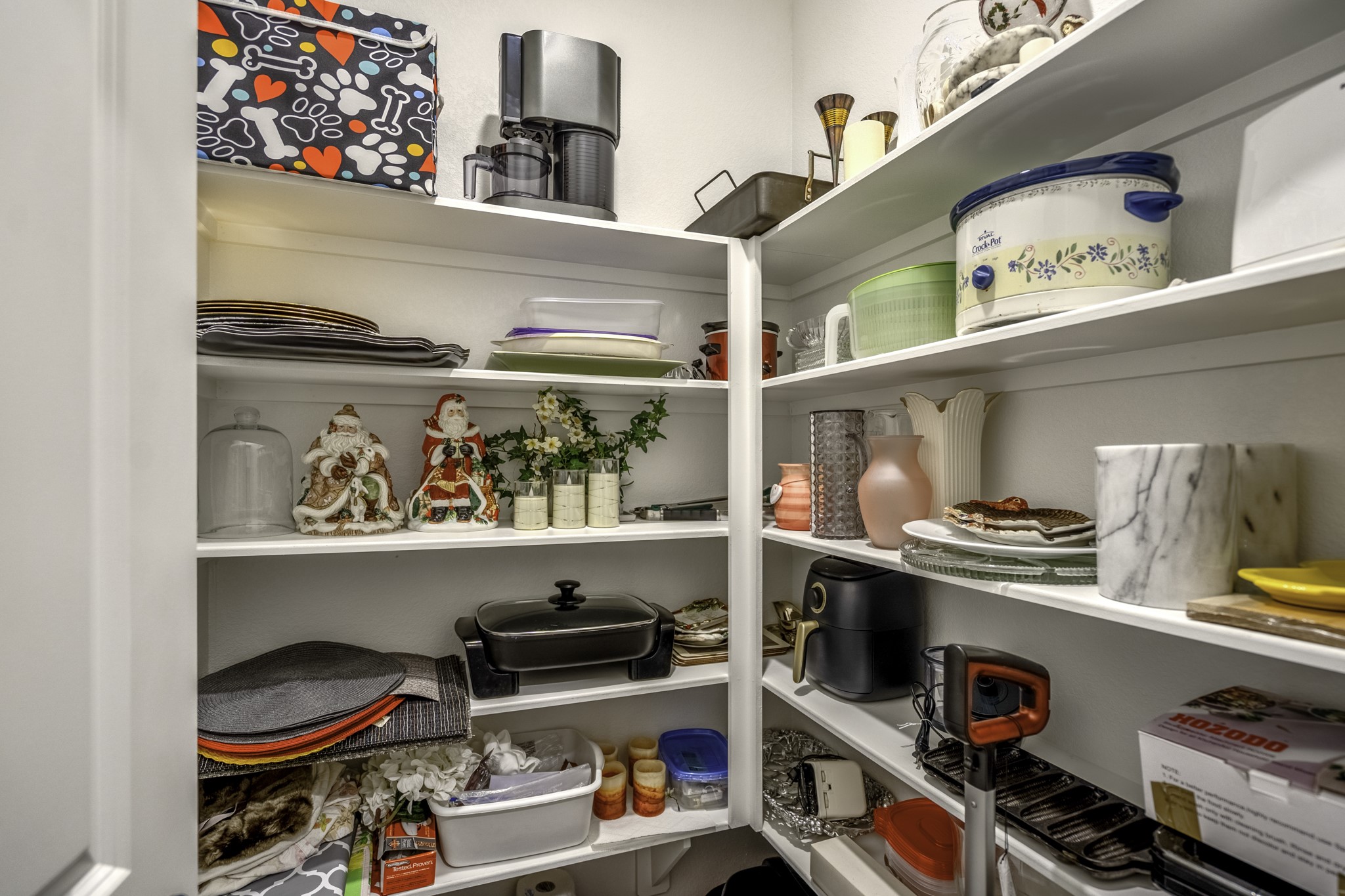 30391 Limber Pines Drive Magnolia, TX 77355 - Photo 25 of 49 This spacious walk-in pantry offers abundant shelving for all your kitchen essentials, combining functionality with charm to enhance your culinary experience.