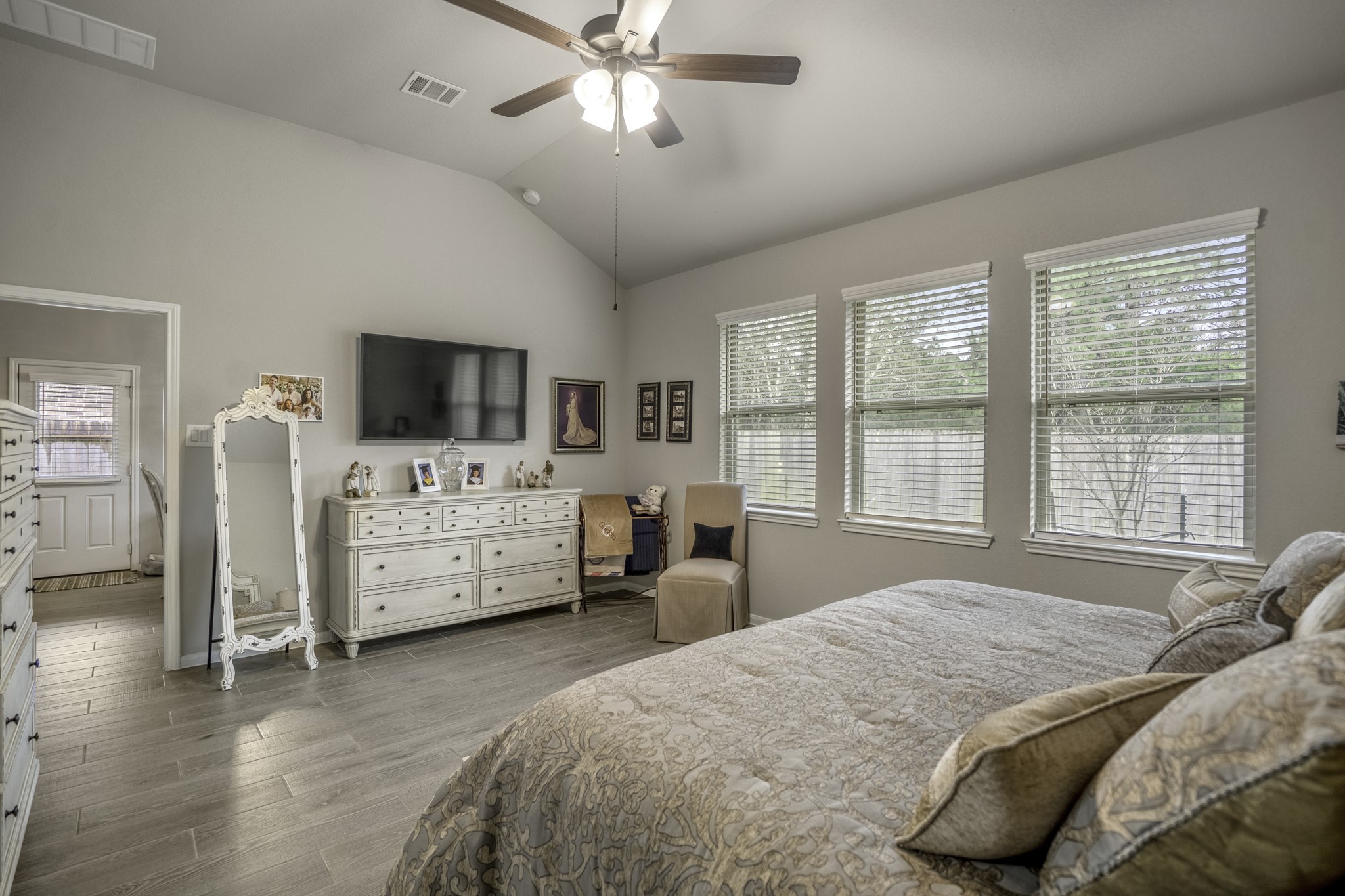 30391 Limber Pines Drive Magnolia, TX 77355 - Photo 30 of 49 This inviting bedroom boasts large windows that flood the space with natural light, creating a warm and welcoming atmosphere.