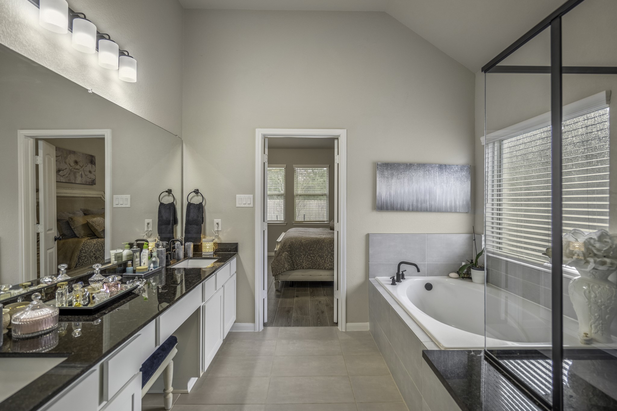 30391 Limber Pines Drive Magnolia, TX 77355 - Photo 33 of 49 This elegant bathroom features a large window that floods the space with natural light, highlighting the sleek design and inviting atmosphere.