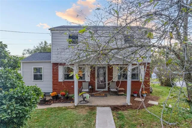 a view of a house with backyard porch and sitting area