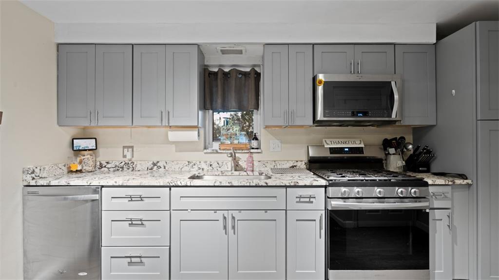 300 Sunset Boulevard Washington, PA 15301 - Photo 12 of 38 a kitchen with granite countertop a sink stove and microwave