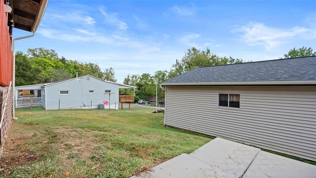 300 Sunset Boulevard Washington, PA 15301 - Photo 30 of 38 a backyard of a house with plants and a tree